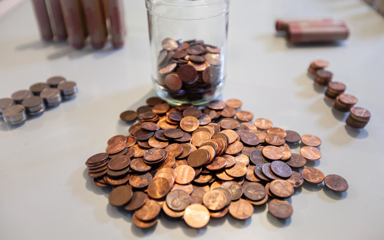 clear container with pennies and coins