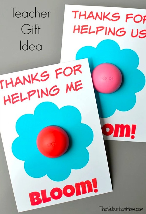 Printable teacher appreciation card that says "Thanks for Helping Me Bloom!" and has a blue flower with Eos lip balm as the center of the flower in red or pink