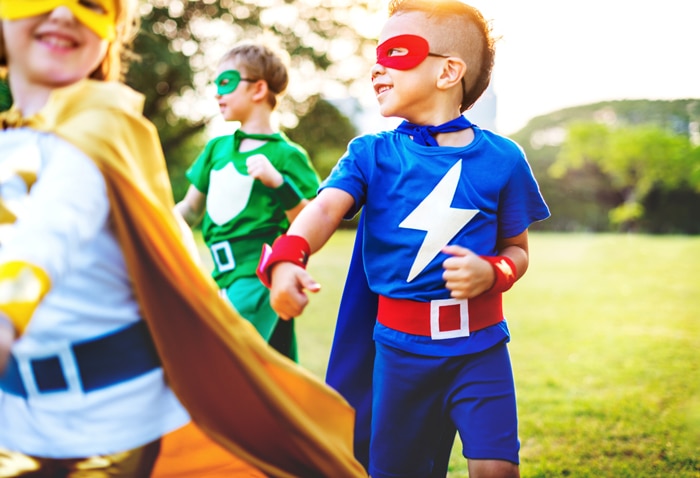 children dressed up in superhero costumes signifying a back to school theme party